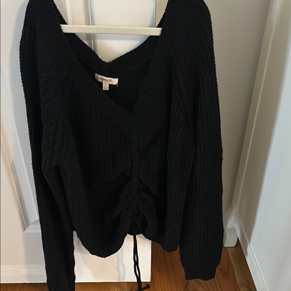 A Peach  Black V-Neck Sweater with Long Sleeves and Relaxed Fit